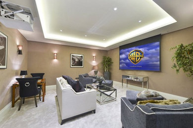 Photo of a medium sized classic enclosed home cinema in London with beige walls, carpet, a projector screen and grey floors.