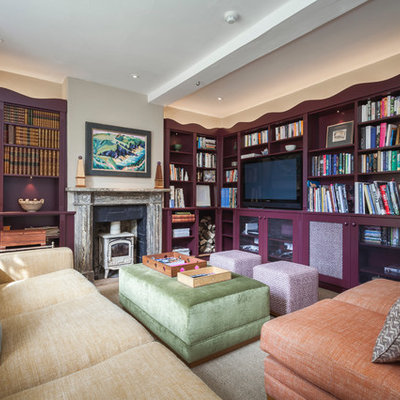 Example of a minimalist home theater design in Wiltshire with a media wall