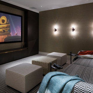 Inspiration for a medium sized contemporary enclosed home cinema in London with brown walls, carpet and a projector screen.