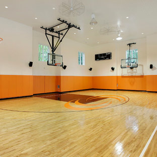 Großer Klassischer Fitnessraum mit Indoor-Sportplatz, bunten Wänden, hellem Holzboden und braunem Boden in Chicago