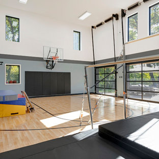 Idee per un grande campo sportivo coperto design con pareti multicolore, parquet chiaro e pavimento marrone