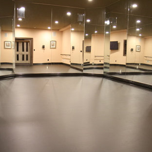This is an example of a mid-sized modern home gym in Newark with dark hardwood floors.