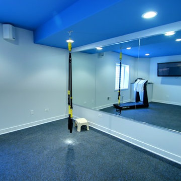 Basement exercise room with mirrored wall
