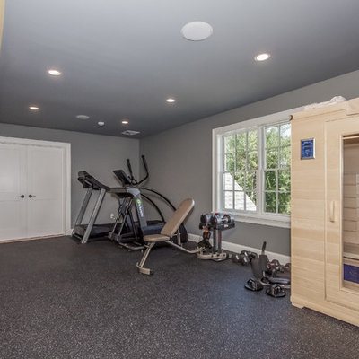 Large minimalist home weight room photo in Boston with gray walls