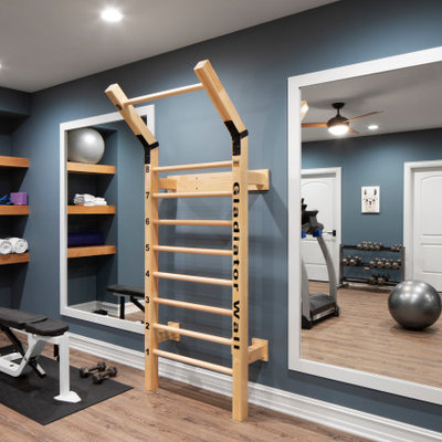 Large transitional light wood floor and beige floor home weight room photo in Milwaukee with blue walls