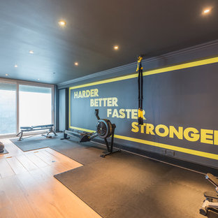 Idee per una grande palestra multiuso minimal con pareti multicolore, parquet chiaro e pavimento marrone