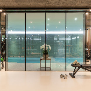 Design ideas for a contemporary multi-use home gym in London with white floors.