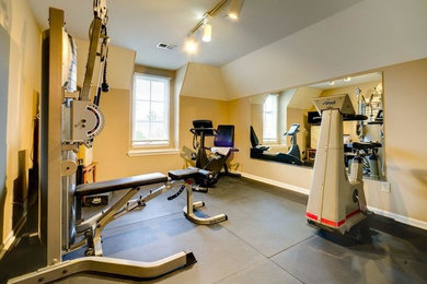 Photo of a medium sized classic home weight room in Other with beige walls and grey floors.