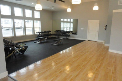 Huge transitional light wood floor and beige floor home weight room photo in DC Metro with gray walls