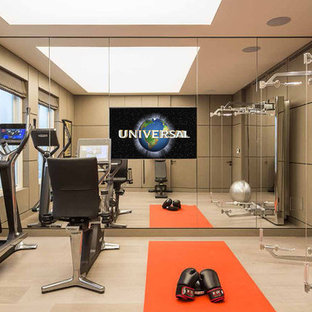 Photo of a small traditional home gym in London with light hardwood flooring.