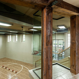Immagine di un campo sportivo coperto classico con pareti beige e parquet chiaro