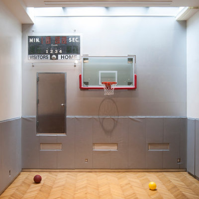 Example of a large trendy light wood floor indoor sport court design in New York with gray walls