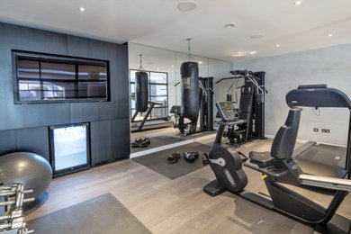 Design ideas for a home gym in London with grey walls.