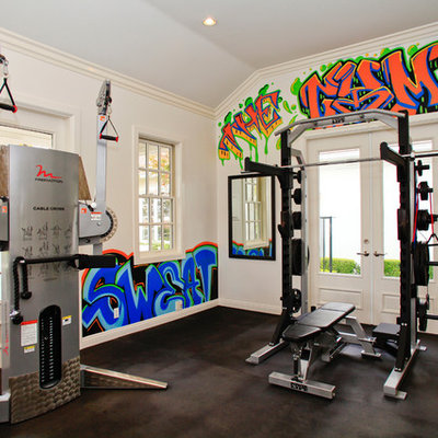 Trendy black floor multiuse home gym photo in Orange County with white walls