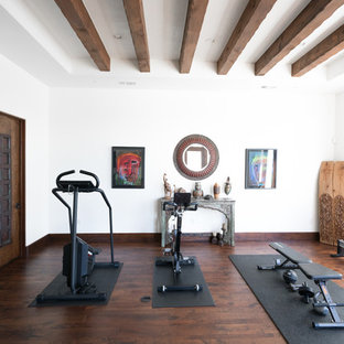 Multiuse home gym - mediterranean dark wood floor and brown floor multiuse home gym idea in Austin with white walls