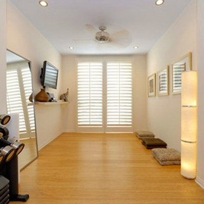 Home weight room - mid-sized light wood floor home weight room idea in Other with white walls