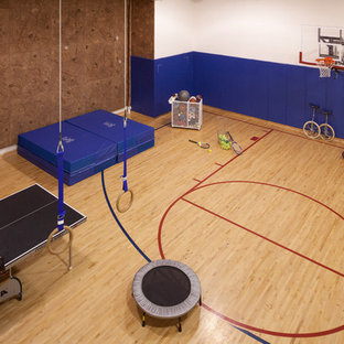 Geräumiger Klassischer Fitnessraum mit Kletterwand, weißer Wandfarbe und hellem Holzboden in Minneapolis