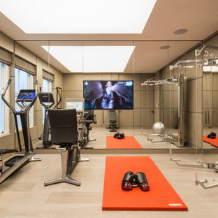Inspiration for a contemporary home gym in Hampshire with grey walls, light hardwood flooring and beige floors.