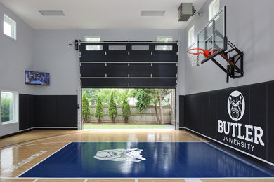 Large traditional indoor sports court in Milwaukee with grey walls, vinyl flooring and blue floors.