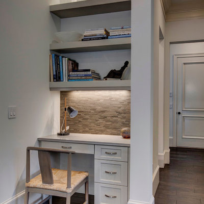 Inspiration for a small transitional built-in desk dark wood floor home office remodel in Orlando with white walls