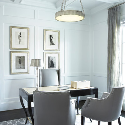 Elegant freestanding desk dark wood floor home office photo in Other with white walls