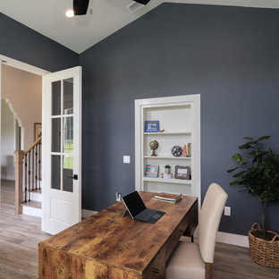 Large cottage freestanding desk porcelain tile and brown floor home office photo in Jacksonville with gray walls