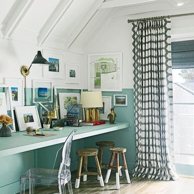 Example of a small eclectic built-in desk medium tone wood floor home studio design in Miami with blue walls