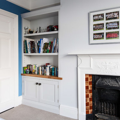Study room - mid-sized contemporary built-in desk carpeted and beige floor study room idea in Kent with white walls, a standard fireplace and a tile fireplace