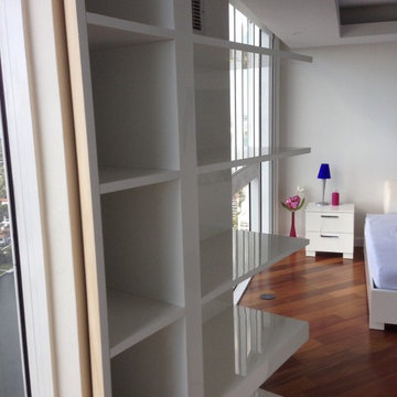Acrylic wall unit with pivoting section to hide master bedroom