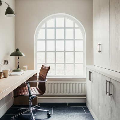 Example of a country freestanding desk black floor study room design in Other with white walls and no fireplace