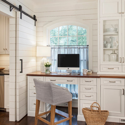 Study room - small traditional built-in desk dark wood floor study room idea in Charlotte with white walls