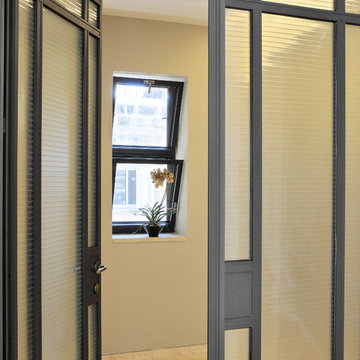 Aluminum and textured glass French doors open to a home office