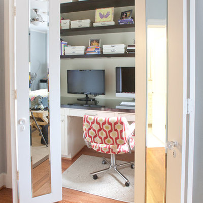 Example of a mid-sized trendy built-in desk medium tone wood floor and brown floor home office design in Dallas with beige walls and no fireplace