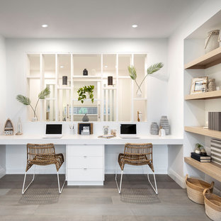 This is an example of a beach style study room in Sydney with white walls, no fireplace, a built-in desk and grey floor.