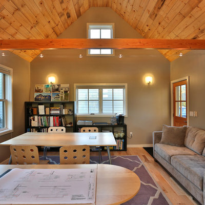 Example of a transitional freestanding desk medium tone wood floor home studio design in Portland Maine with gray walls