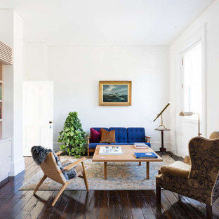 Photo of a large eclectic study room in Sydney with white walls, dark hardwood floors, a freestanding desk and brown floor.