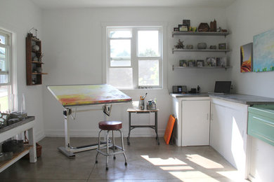 Inspiration for a small industrial freestanding desk concrete floor home studio remodel in Grand Rapids with white walls and no fireplace