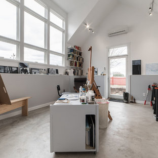 Example of a large minimalist freestanding desk concrete floor and gray floor craft room design in Chicago with multicolored walls