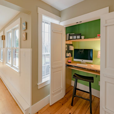 Study room - small farmhouse built-in desk brown floor and medium tone wood floor study room idea in Boston with green walls