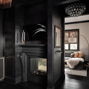 Inspiration pour un bureau traditionnel de taille moyenne avec un mur noir, un sol en bois foncé, une cheminée double-face, un manteau de cheminée en bois et un sol noir.