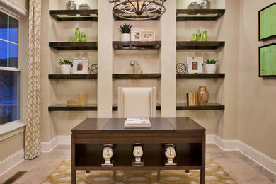 This is an example of a medium sized classic study in Raleigh with beige walls and a freestanding desk.