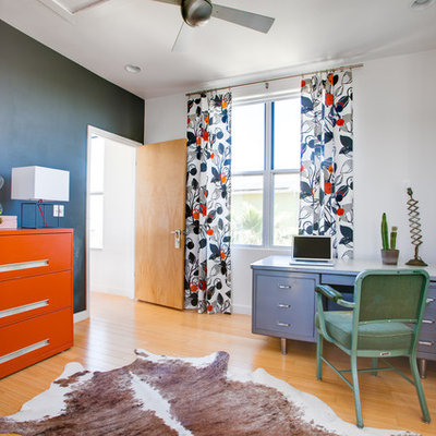 Inspiration for an eclectic freestanding desk medium tone wood floor home office remodel in Austin with white walls