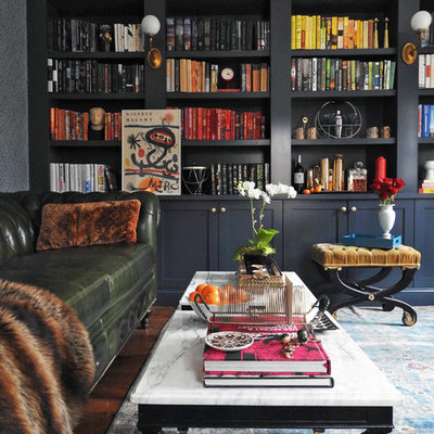 Inspiration for a mid-sized timeless medium tone wood floor and brown floor home office library remodel in New York with gray walls and no fireplace