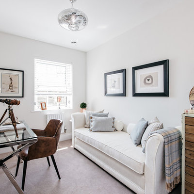 Farmhouse freestanding desk carpeted study room photo in London with white walls