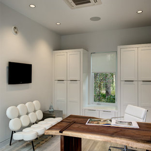 Home office - contemporary freestanding desk light wood floor home office idea in Orlando with white walls
