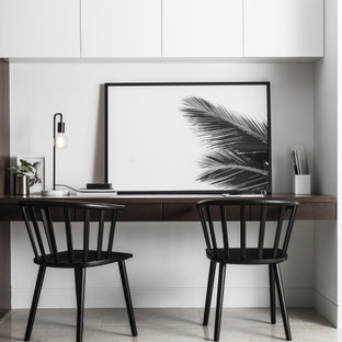 Inspiration for a mid-sized contemporary study room in Sydney with white walls, a built-in desk and grey floor.