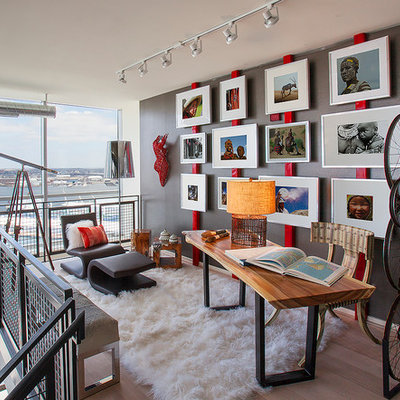 Inspiration for a small industrial freestanding desk light wood floor and brown floor study room remodel in DC Metro with gray walls and no fireplace