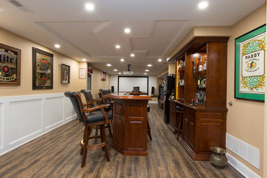 Inspiration for a large craftsman vinyl floor home office remodel in Other with beige walls
