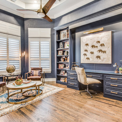 Inspiration for a coastal built-in desk medium tone wood floor and brown floor study room remodel in Dallas with blue walls
