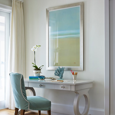 Beach style freestanding desk medium tone wood floor study room photo in San Diego with beige walls